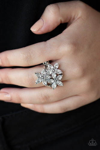 Featuring glassy white rhinestone petals, a trio of flowers bloom atop the finger for a whimsical flair. Features a dainty stretchy band for a flexible fit.  Sold as one individual ring.  Always nickel and lead free.
