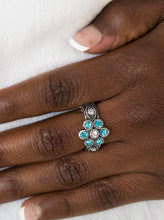 Load image into Gallery viewer, Glittery blue rhinestones bloom from a white rhinestone center, creating a glamorous floral band. Features a dainty stretchy band for a flexible fit.  Sold as one individual ring. 