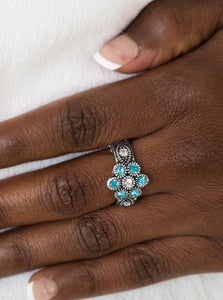Glittery blue rhinestones bloom from a white rhinestone center, creating a glamorous floral band. Features a dainty stretchy band for a flexible fit.  Sold as one individual ring. 