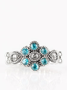 Glittery blue rhinestones bloom from a white rhinestone center, creating a glamorous floral band. Features a dainty stretchy band for a flexible fit.  Sold as one individual ring.