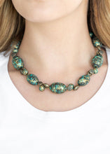 Load image into Gallery viewer, Featuring a brassy patina finish, a collection of ornate beads and an array of floral stamped brass beads are threaded along a brass wire below the collar for a seasonal flair. Features an adjustable clasp closure.  Sold as one individual necklace. Includes one pair of matching earrings.  Always nickel and lead free.