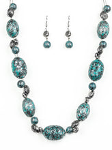 Load image into Gallery viewer, Featuring a silvery patina finish, a collection of ornate beads and an array of floral stamped silver beads are threaded along invisible wire below the collar for a seasonal flair. Features an adjustable clasp closure.  Sold as one individual necklace. Includes one pair of matching earrings.