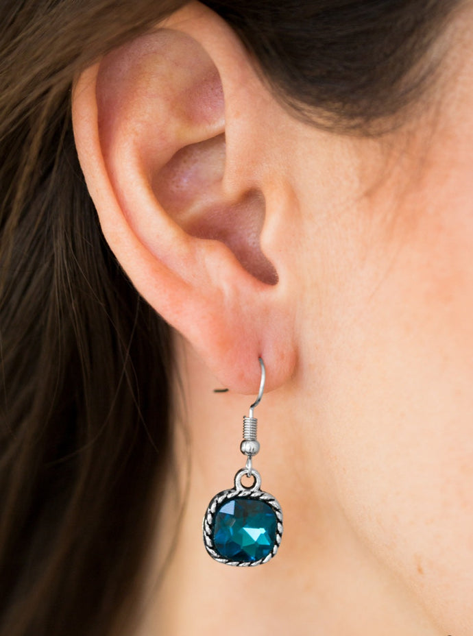 Chiseled into an alluring square style cut, a faceted blue gem is pressed into a serrated silver frame for a regal look. Earring attaches to a standard fishhook fitting.  Sold as one pair of earrings.
