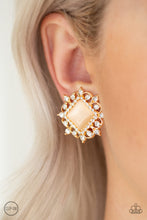 Load image into Gallery viewer, Featuring a regal square cut, a glowing peach moonstone is pressed into the center of an ornate gold frame radiating with glassy white rhinestones for a timeless look. Earring attaches to a standard clip-on fitting.  Sold as one pair of clip-on earrings.  Always nickel and lead free.