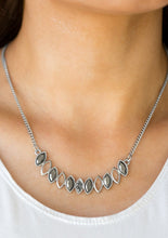 Load image into Gallery viewer, Necklace and Earrings: Featuring regal marquise style shapes, shimmery silver frames join below the collar. The sparkling pendant features mismatched hematite rhinestone accents for a refined finish. Features an adjustable clasp closure.  Bracelet: Featuring regal marquise style shapes, shimmery silver frames join across the wrist. Attached to two dainty silver bars, the sparkling centerpiece features mismatched hematite rhinestone accents for a refined finish. Features an adjustable clasp closure.