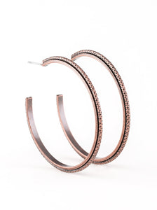 Etched in diamond cut textures, a shimmery copper hoop curls around a smooth copper frame, coalescing into an edgy hoop. Earring attaches to a standard post fitting. Hoop measures 2" in diameter.  Sold as one pair of hoop earrings.