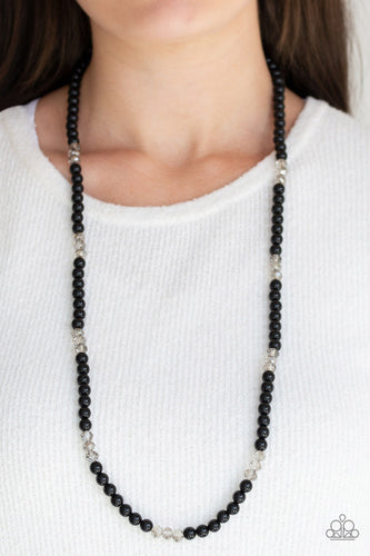 Infused with sections of smoky crystal-like beads, a timeless collection of black beads are threaded along an invisible wire across the chest for a refined flair. Features an adjustable clasp closure.  Sold as one individual necklace. Includes one pair of matching earrings.  