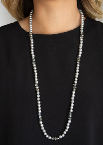 Infused with sections of smoky crystal-like beads, a timeless collection of silver pearls are threaded along an invisible wire across the chest for a refined flair. Features an adjustable clasp closure.  Sold as one individual necklace. Includes one pair of matching earrings.
