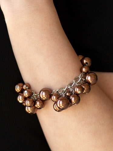 Clusters of classic and oversized brown pearls swing from a pearl beaded silver chain, creating a fabulous fringe. Features an adjustable clasp closure.  Sold as one individual bracelet.  Always nickel and lead free.
