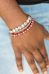   Mismatched silver and pearly red beads are threaded along stretchy elastic bands, creating colorful layers across the wrist.  Sold as one set of three bracelets.  Always nickel and lead free.