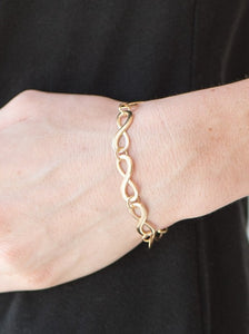 Glistening gold infinity charms link around the wrist. Brushed in an incandescent shimmer, the elegant infinities join into a timeless palette. Features an adjustable clasp closure.  Sold as one individual bracelet.  