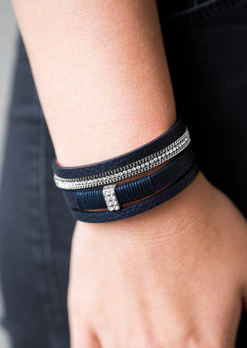 Brushed in a glistening finish, shimmery dark blue leather strands layer across the wrist in a colorful urban fashion. Strands of shimmery silver chain and dazzling white rhinestones adorn leather strands for a glamorous finish. Features an adjustable clasp closure. 