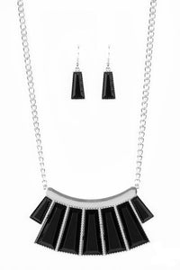 Faceted black emerald style beads are pressed into a hammered silver plate. Featuring flared bottoms, the bold beads fan out below the collar for a fierce finish. Features an adjustable clasp closure.  Sold as one individual necklace. Includes one pair of matching earrings.