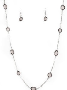 Featuring sleek silver fittings, an array of glassy smoky gemstones trickle along a shimmery silver chain for a glamorous look. Features an adjustable clasp closure.  Sold as one individual necklace. Includes one pair of matching earrings.  Always nickel and lead free.