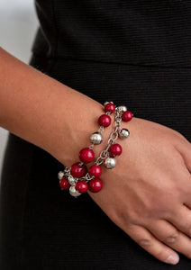 Mismatched strands of shiny silver and hearty wine beads wrap around the wrist, creating colorful boisterous movement. Features an adjustable clasp closure.