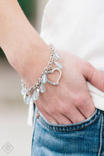 Load image into Gallery viewer, Crystal-like teardrops in the spring hue of Blue Radiance drip from the bottom of a shimmery silver chain. Stamped in ornate patterns, glistening silver heart silhouettes trickle between the colorful accents, creating a whimsical fringe around the wrist. Features an adjustable clasp closure.