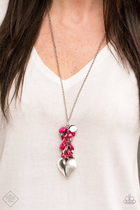  Infused with an array of pink beads, a collection of antiqued silver shell and butterfly charms trickle along the bottom of a shimmery silver chain. Complemented with a glittery white rhinestone encrusted bead, a dramatically oversized silver heart pendant swings from the bottom of the clustered tassel for a whimsical finish. Features an adjustable clasp closure