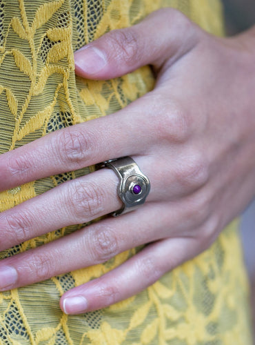 A dainty plum bead is pressed into the center of a rounded gunmetal band for a sleek minimalist look. Features a stretchy band for a flexible fit.  Sold as one individual ring.    Glimpses of Malibu January 2019  