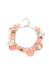 Load image into Gallery viewer, Springtime charms of shiny and soft beads and pearl-like discs in lovely tones of Burnt Coral sway from a silver chain. Accents of sparkly, wavy silver discs and wooden beads bring it down to earth as the fringe wraps around the wrist. Features an adjustable clasp closure..