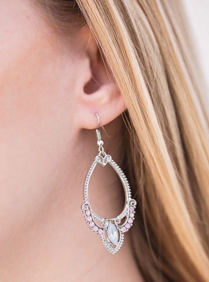 A silver teardrop frame is bordered in sparkling rhinestones and embellished with swooping silver bars and opulent pink gems across the bottom. A daring marquise cut gem sparkles at the bottom of the whimsical frame, adding a touch of glamour to the bohemian design. Earring attaches to a standard fishhook fitting.  Sold as one pair of earrings.
