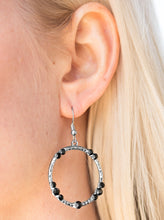 Load image into Gallery viewer, Glittery black rhinestones are sporadically sprinkled along a hammered silver hoop, creating a shimmery lure. Earring attaches to a standard fishhook fitting.  Sold as one pair of earrings.