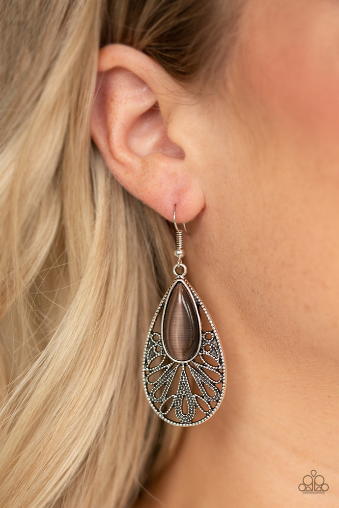 Dotted filigree flares out from the bottom of a blue cat's eye stone, coalescing into an ornate teardrop frame. Earring attaches to a standard fishhook fitting.  Sold as one pair of earrings.  Always nickel and lead free.