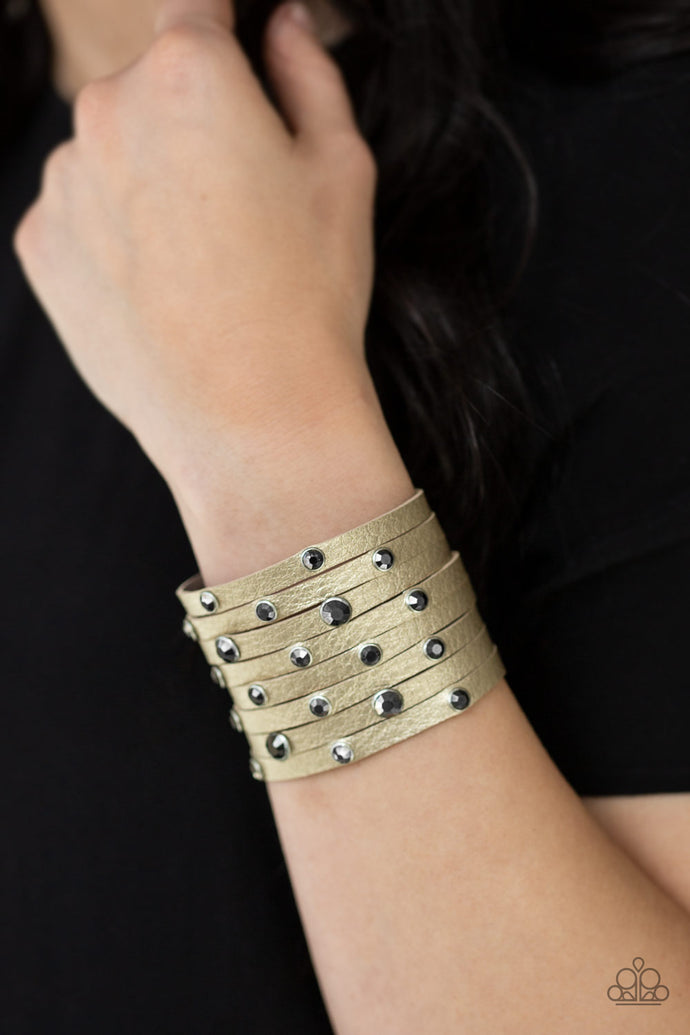 Brushed in a metallic shimmer, a thick leather band has been spliced into eight strips across the wrist. Encased in sleek silver fittings, glittery hematite rhinestones are sprinkled across the center for a sassy finish. Features an adjustable snap closure.  Sold as one individual bracelet.  Always nickel and lead free.