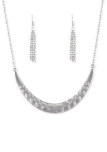 Load image into Gallery viewer, Stamped in tribal inspired patterns, a silver crescent-shaped plate swings from the bottom of a shimmery silver chain, creating a bold pendant below the collar. Features an adjustable clasp closure.   Sold as one individual necklace. Includes one pair of matching earrings.