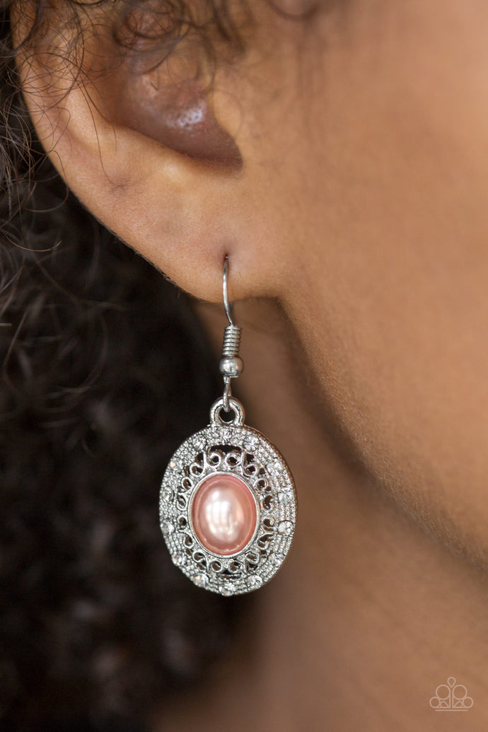 A pearly orange bead is pressed into the center of an ornate silver frame radiating with glassy white rhinestones for a regal look. Earring attaches to a standard fishhook fitting.  Sold as one pair of earrings.  Always nickel and lead free.