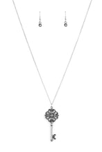 Load image into Gallery viewer, Dotted with a glittery hematite rhinestone, a vintage inspired key pendant swings from the bottom of an elegantly elongated silver chain for a whimsical look. Features an adjustable clasp closure.  Sold as one individual necklace. Includes one pair of matching earrings.