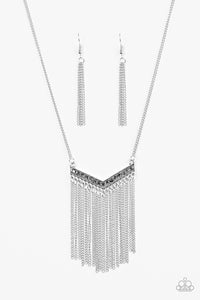 Encrusted in glittery hematite rhinestones, a V-shaped frame gives way to silver fringe. Infused with an elongated silver chain, the tapered fringe adds flirty movement to the piece, while elegantly lengthening the torso. Features an adjustable clasp closure.  Includes one pair of matching earrings.