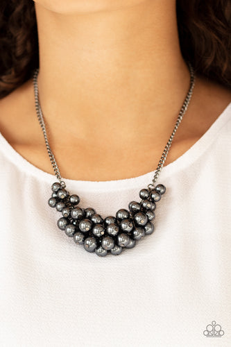A collection of pearly gunmetal beads dangle from the bottom of a glistening gunmetal chain, creating a glamorously clustered display below the collar. Features an adjustable clasp closure.  Sold as one individual necklace. Includes one pair of matching earrings. Always nickel and lead free.