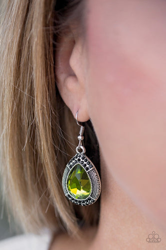 A faceted green teardrop gem is pressed into a shimmery silver frame radiating with studded details and glittery black rhinestones for a magnificent look. Earring attaches to a standard fishhook fitting.  Sold as one pair of earrings.  Always nickel and lead free.