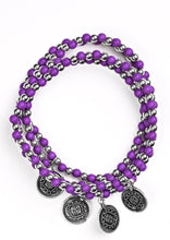 Load image into Gallery viewer, Dainty purple and silver beads are threaded along stretchy elastic bands, creating colorful layers across the wrist. Brushed in an antiqued shimmer, ornate silver charms swing from the wrist for a wanderlust finish.  Sold as one set of four bracelets.