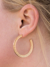 Load image into Gallery viewer, Etched in a scratched shimmer, a flat gold bar curls around the ear, creating a blinding sparkle. Earring attaches to a standard post fitting. Hoop measures 1 1/2” in diameter.  Sold as one pair of hoop earrings.  
