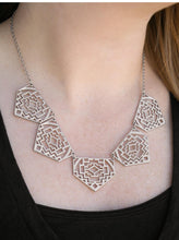 Load image into Gallery viewer, Shimmery metallic plates swing from a classic silver chain, creating a geometric fringe. Decorated in a Southwestern textile pattern, the stenciled plates fall just below the collar in an airy fashion. Features an adjustable clasp closure.  Sold as one individual necklace. Includes one pair of matching earrings.