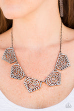 Load image into Gallery viewer, Shimmery metallic plates swing from a classic gunmetal chain, creating a geometric fringe. Decorated in a Southwestern textile pattern, the stenciled plates fall just below the collar in an airy fashion. Features an adjustable clasp closure.  Sold as one individual necklace. Includes one pair of matching earrings.  Always nickel and lead free.