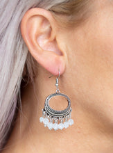 Load image into Gallery viewer, Opaque white crystal-like beads swing from the bottom of a studded round silver frame, creating a twinkling fringe. Earring attaches to a standard fishhook fitting.  Sold as one pair of earrings.