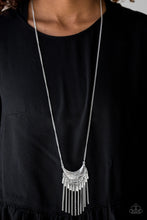 Load image into Gallery viewer, Radiating in linear textures, a glistening silver crescent swings from the bottom of a lengthened silver chain. Shimmery silver chains and flared silver beading swings from the bottom of the tribal inspired pendant, creating a flirtatious fringe. Features an adjustable clasp closure.  Sold as one individual necklace. Includes one pair of matching earrings.  Always nickel and lead free.