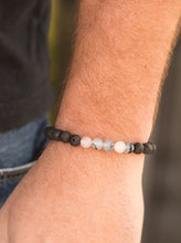 Load image into Gallery viewer, Glassy white and earthy black lava stones are threaded along a stretchy elastic band for a seasonal look.  Sold as one individual bracelet.