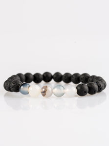 Glassy white and earthy black lava stones are threaded along a stretchy elastic band for a seasonal look.  Sold as one individual bracelet.