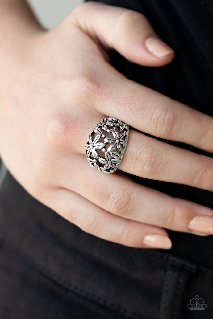 Brushed in antiqued details, glistening silver flowers bloom across the finger, coalescing into a whimsical band. Features a stretchy band for a flexible fit.  Sold as one individual ring.  Always nickel and lead free.