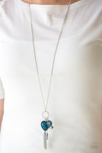Load image into Gallery viewer, Infused with a lengthened silver chain, an array of glassy blue and shimmery silver accents swing from the bottom of a white rhinestone encrusted frame. A faceted blue heart frame swings from the bottom of the sparkling frame, adding a romantic finish to the whimsical tassel. Features an adjustable clasp closure.  Sold as one individual necklace. Includes one pair of matching earrings.