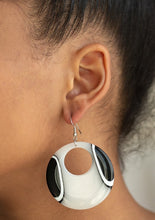 Load image into Gallery viewer, Swirling with dizzying black and white detail, a shiny acrylic hoop swings from the ear for a retro look. Earring attaches to a standard fishhook fitting.  Sold as one pair of earrings.