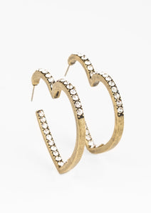 Encrusted in sections of glittery white rhinestones, a glistening brass hoop curls into a charming heart shape for a heart-stopping look. Earring attaches to a standard post fitting. Hoop measures approximately 2" in diameter.  Sold as one pair of hoop earrings.