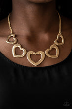 Load image into Gallery viewer, Gradually increasing in size, glistening gold heart silhouettes delicately link below the collar in a charming fashion. Features an adjustable clasp closure.  Sold as one individual necklace. Includes one pair of matching earrings.  Always nickel and lead free.