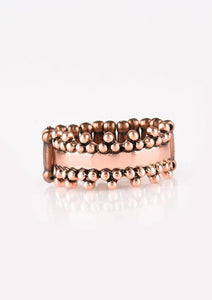Trios of shimmery copper studs dot the top and bottom of an antiqued copper band for an edgy industrial look. Features a dainty stretchy band for a flexible fit. Sold as one individual ring.
