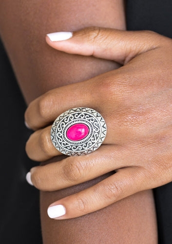 A glowing pink stone is pressed in the center of a dramatic silver frame radiating with shimmery sunburst details for a seasonal look. Features a stretchy band for a flexible fit.  Sold as one individual ring.  