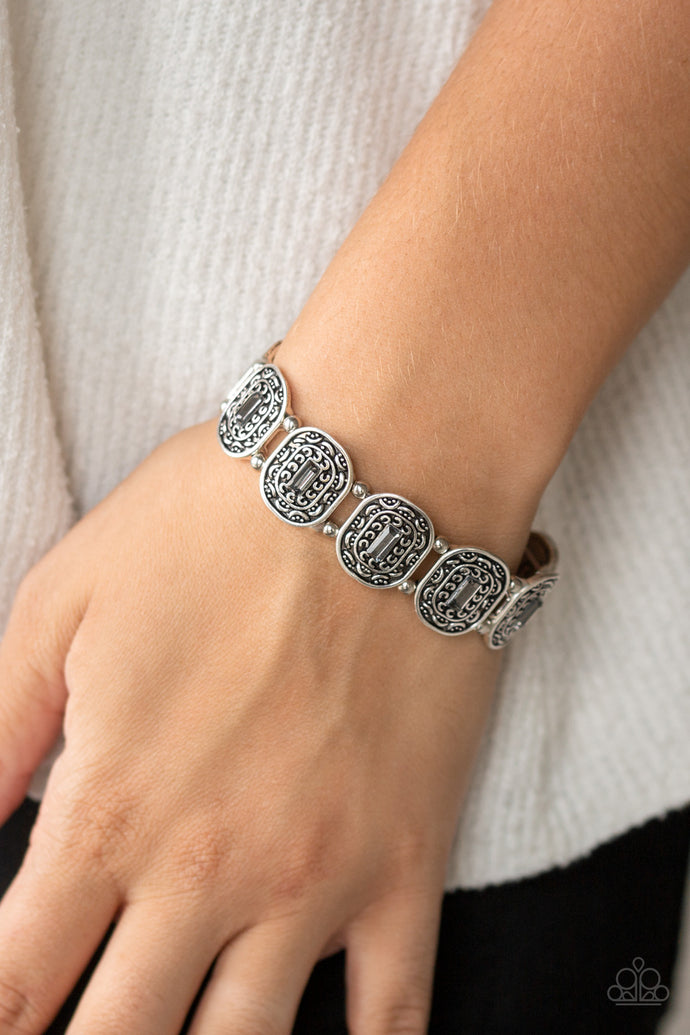 Featuring black and hematite emerald-cut rhinestone centers, ornate silver frames are threaded along stretchy bands around the wrist for a refined fashion.  Sold as one individual bracelet. Always nickel and lead free.