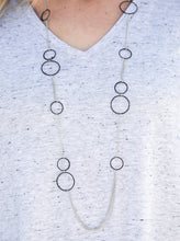 Load image into Gallery viewer, Tinted in a bold finish, shiny black hoops trickle along dainty silver chain, creating a colorful asymmetrical palette. Features an adjustable clasp closure.  Sold as one individual necklace. Includes one pair of matching earrings.  